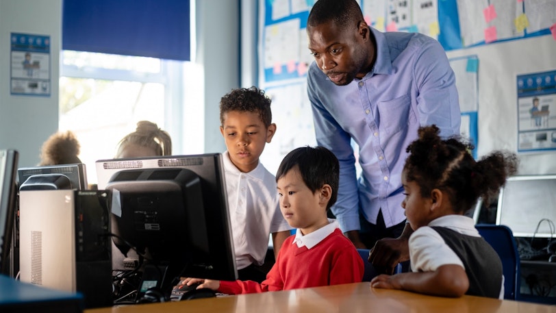 Stock Teacher and students on computers 3 1340023767